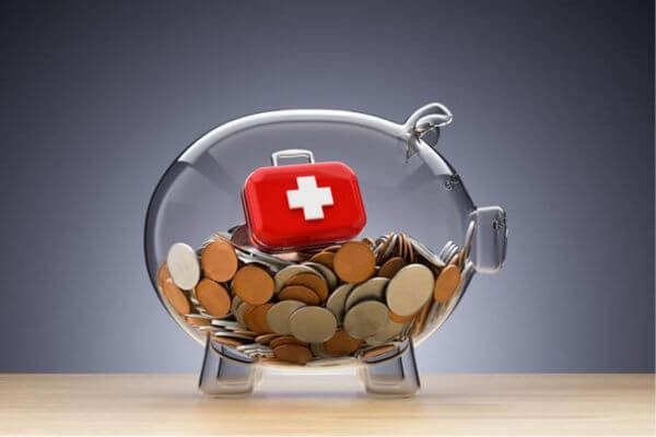 Person putting coins into a jar for an emergency fund